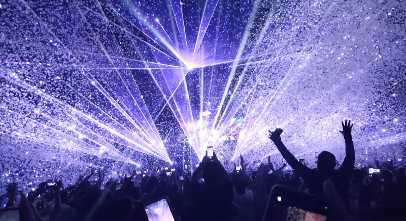 A concert stage with vibrant laser lights